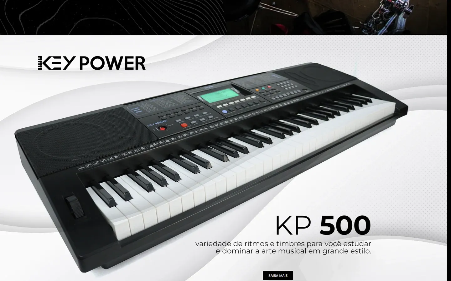 Faixa da Key Power com o teclado KP 500 em destaque sobre fundo claro, o texto sobre ritmos e timbres e o botão Saiba mais.